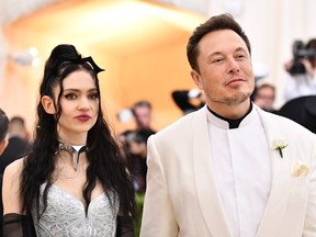 Grimes, left, and Elon Musk attend The Metropolitan Museum of Art's Costume Institute benefit gala celebrating the opening of the Heavenly Bodies: Fashion and the Catholic Imagination exhibition on Monday, May 7, 2018, in New York.