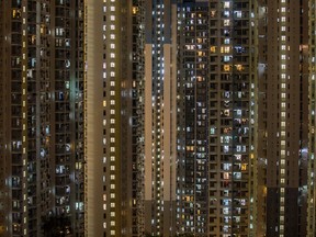 Residential buildings stand illuminated in Hong Kong, China.
