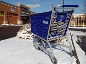 An empty shopping cart sits outside a Sears store in the Streets of Southglenn mall in Littleton, Colo.
