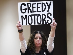 Jenn Scowie, a General Motor employee who will directly affected by the General Motors Oshawa plant closure, shows her support before Unifor National President Jerry Dias announces the boycott Friday.