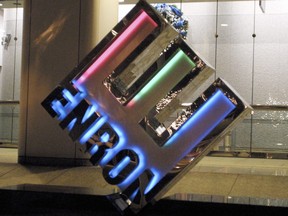 A logo glows in front of the new corporate headquarters of the Houston-based energy trading firm Enron November 29, 2001 in Houston, Texas.