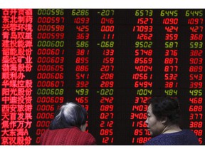 Women chat as they monitor stock prices at a brokerage house in Beijing, Friday, Feb. 1, 2019. Asian markets were mixed on Friday as trade talks ended in Washington with no deal but the promise of a second meeting between U.S. President Donald Trump and Chinese leader Xi Jinping. Gains were limited by a private survey showing that Chinese manufacturing slowed to the lowest level in almost three years.