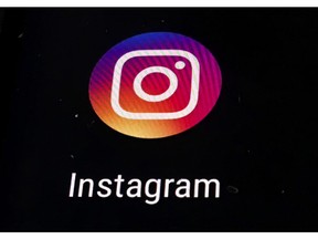 FILE  - In this Thursday, Nov. 29, 2018 file photo, the Instagram app logo is displayed on a mobile screen in Los Angeles. Instagram has agreed to ban graphic images of self-harm after objections were raised in Britain following the suicide of a teen whose father said the photo-sharing platform had contributed to her decision to take her own life.