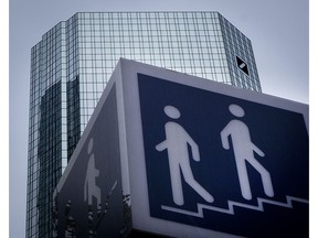FILE - The May 24, 2018 file photo shows a sign for a pedestrians in front of the Deutsche Bank towers, on the day of the annual meeting of the bank, in Frankfurt, Germany.