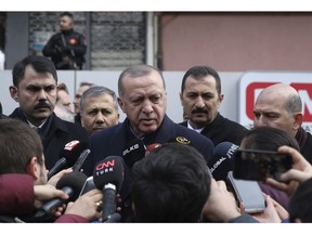 Turkey's President Recep Tayyip Erdogan speaks to the media as he visits the site of a collapsed building in Istanbul, Saturday, Feb. 9, 2019. Erdogan says there are "many lessons to learn" from the collapse of a residential building in Istanbul where at least 17 people have died. (Presidential Press Service via AP, Pool)