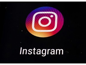 FILE - In this Thursday, Nov. 29, 2018, file photo, the Instagram app logo is displayed on a mobile screen in Los Angeles. Instagram has removed an account that published comic strips depicting the struggles of gay Muslims in Indonesia following a frenzy of moral outrage online in the world's biggest Muslim nation.