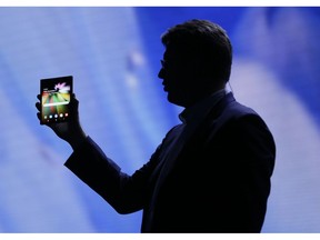 FILE - In this Nov. 7, 2018 file photo,, Justin Denison, SVP of Mobile Product Development, shows off the Infinity Flex Display of a folding smartphone during the keynote address of the Samsung Developer Conference, in San Francisco. Samsung is expected to show off its latest smartphones Wednesday, Feb. 20, 2019, the latest effort by a phone maker to come up with new features compelling enough to end a sales slump.