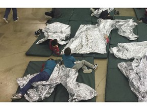 FILE - In this June 17, 2018 file photo provided by U.S. Customs and Border Protection, people who've been taken into custody related to cases of illegal entry into the United States, rest in one of the cages at a facility in McAllen, Texas. Months after the Trump administration ended the general policy of separating parents and children, advocates and members of Congress are questioning the treatment of children who cross the U.S.-Mexico border with other relatives - grandparents, uncles and aunts, and adult siblings. (U.S. Customs and Border Protection's Rio Grande Valley Sector via AP, File)