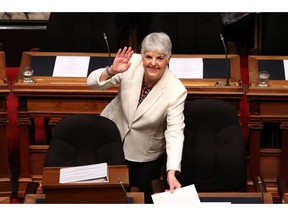 Finance Minister Carole James arrives to deliver the budget speech as she waves to people in the gallery at the legislature in Victoria, B.C., on Tuesday, February 19, 2018.