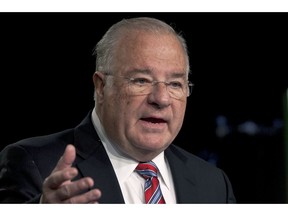 FILE - In this Feb. 14, 2012 file photo, online brokerage TD Ameritrade founder Joe Ricketts speaks during a ceremonial unveiling of his portrait which will hang in company headquarters in Omaha, Neb. The patriarch of the family behind the Chicago Cubs has apologized after an online media outlet published emails in which he took part in racist comments and conspiracy theories. Some of the emails Splinter News published Monday, Feb. 4, 2019, featured Ricketts making Islamophobic comments. Others included conspiracies about former President Barack Obama's birthplace and education. Ricketts apologized for the emails, saying he believes "bigoted ideas are wrong."