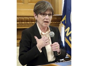 FILE - In this Jan. 24, 2019, file photo, Kansas Gov. Laura Kelly answers questions from reporters during a news conference at the Statehouse in Topeka, Kan. Kelly's fellow Democrats are describing a tax relief plan moving through the Republican-controlled Legislature as a give-away to large corporations, and GOP leaders acknowledge that big businesses would benefit, by design. The state Senate planned to take a final vote Thursday, Feb. 7, 2019, on a bill that is designed to prevent Kansas residents and businesses from paying higher state income taxes because of changes in federal tax laws at the end of 2017.