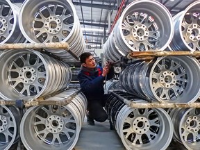 A worker checking wheels at a factory in Lianyungang in China's eastern Jiangsu province. The Chinese economy is slipping into structural stagnation.