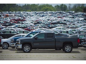 Vehicles are seen in a parking lot at the General Motors Oshawa Assembly Plant in Oshawa, Ont., on Wednesday, June 20, 2018.