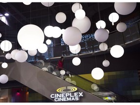 A woman leaves the Cineplex theatre in Toronto on Friday, November 4, 2016. Cineplex Inc. says it had $27.2 million of net income in the fourth quarter, down from $28.8 million a year earlier, as attendance at its theatres declined.