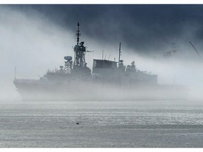 HMCS St. John's, one of Canada's Halifax-class frigates, heads through the fog as it returns to port in Halifax on Monday, July 23, 2018. Ottawa will spend $183 million on the upgrading and maintaining of underwater sensors for the Royal Canadian Navy's frigates.