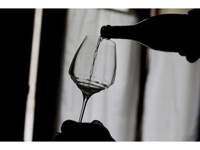 A man pours a bottle of Prosecco during a wine tasting at the Case Paolin farm, in Volpago del Montello, Italy on Oct. 15, 2018. A court placed Mike Weir Wine Inc. into receivership as the winery owes more than $6 million.