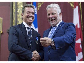 Famous chef Ricardo Larrivee is decorated as Chevalier by Quebec Premier Philippe Couillard at the Ordre national du Quebec ceremony, Thursday, June 22, 2017 at the legislature in Quebec City. Ricardo Media is shutting down its English-language food magazine, citing high distribution costs and shift towards digital media.