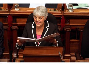 Finance Minister Carole James shares a laugh with a colleague before delivering the budget speech from the legislative assembly at Legislature in Victoria, B.C., on February 20, 2018.