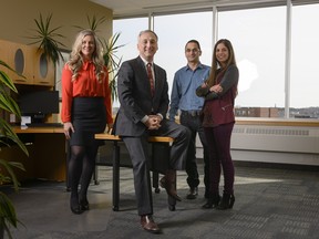 Bernard Lord, CEO of Medavie Blue Cross, second from left, poses with employees, from left to right, Maureen Welsman, David Kabalen, and Swati Bhuchar pose at the company's office in Halifax on Friday, February 15, 2019.