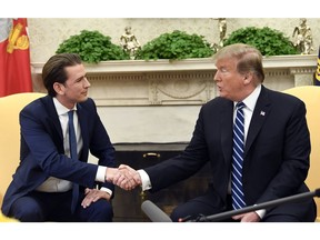 President Donald Trump shakes hands as he meets with Austrian Chancellor Sebastian Kurz in the Oval Office of the White House in Washington, Wednesday, Feb. 20, 2019.