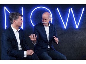 File -- In this Friday, Feb. 22, 2019 photo Harald Krueger, left, CEO of the car manufacturer BMW, and Dieter Zetsche, right, CEO of the Daimler stock company and the car manufacturer Mercedes Benz, talk during a press conference in Berlin, Germany. Automakers BMW and Daimler said on Thursday, Feb 28, 2019 they will work together on developing the automated driving technology expected to transform the industry in the years ahead.