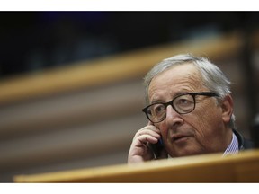 European Commission President Jean-Claude Juncker talks on his cellphone at the European Parliament in Brussels, Thursday, Jan. 31, 2019. European Union leaders offered a united chorus of "No" on Wednesday to Britain's belated bid to negotiate changes to the Brexit divorce deal, with one official calling on British lawmakers to stop bickering and work out a cross-party approach.