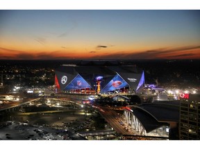 The sun sets behind Mercedes-Benz Stadium ahead of Sunday's NFL Super Bowl 53 football game between the Los Angeles Rams and New England Patriots in Atlanta, Wednesday, Jan. 30, 2019.