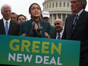 Democratic Congresswoman Alexandria Ocasio-Cortez and Sen. Ed Markey, right, unveil their Green New Deal plan in front of the U.S. Capitol on Feb. 7, 2019, in Washington.