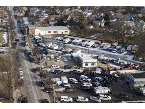 Law enforcement personnel gather near the scene of a shooting at an industrial park in Aurora, Ill., on Friday, Feb. 15, 2019.