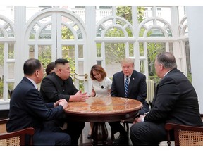 ALTERNATE CROP OF KNS802 - In this Thursday, Feb. 28, 2019, photo provided Friday, March 1, 2019, by the North Korean government, U.S. President Donald Trump, second from right, and North Korean leader Kim Jong Un, second from left, talk at a hotel in Hanoi, Vietnam. U.S. Sec. of State Mike Pompeo is at right. Kim Yong Chol, a North Korean senior ruling party official and former intelligence chief is at left. The content of this image is as provided and cannot be independently verified. (Korean Central News Agency/Korea News Service via AP)