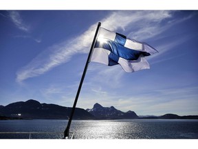 FILE - In this Saturday, July 29, 2017 file photo, Finland's flag flies aboard the Finnish icebreaker MSV Nordica as it arrives into Nuuk, Greenland. A nationwide experiment with basic income in Finland has not increased employment among those participating during the first half of the two-year trial, but their general well-being seems to have increased, a report said Friday Feb. 8, 2019.