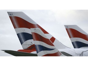 FILE - In this file photo dated Tuesday, Jan. 10, 2017, British Airways planes are parked at Heathrow Airport in London. ﻿﻿﻿﻿﻿﻿﻿﻿  The parent company of British Airways, International Airlines Group consortium is buying up to 42 Boeing 777 long-haul passenger jets in a multi-billion dollar deal announced Thursday Feb. 28, 2019.