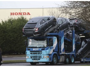 A car transporter leaves the Honda car plant in Swindon, western England, Monday Feb. 18, 2019.  The Japanese carmaker Honda will close a car factory in western England with the potential loss of some 3,500 jobs, according to media reports Monday and confirmed by local lawmaker Justin Tomlinson.