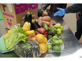 FILE - This Nov. 13, 2018 file photo shows various fruit and vegetables at Imperfect Produce in Severn, Md. The company delivers produce that have been rejected by grocery stores for not fitting cosmetic standards.