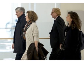 Former CEO of Global Wealth Management and Business Banking at UBS AG Raoul Weil, left, his wife, 2nd left, former General Director of UBS France Patrick de Fayet, 2nd right, and one member of their legal team arrive for the the Swiss bank's trial at the Paris courthouse in Paris, France, Wednesday, Feb. 20, 2019. A Paris court has ordered Swiss bank UBS to pay 3.7 billion euros ($4.2 billion) in fines for helping wealthy French clients evade tax authorities.