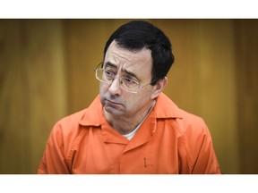 FILE - In this Feb. 2, 2018, file photo, Larry Nassar listens as Melissa Alexander Vigogne gives her victim statement in Eaton County Circuit Court in Charlotte, Mich. The first woman to publicly accuse the now-imprisoned sports doctor of sexual abuse is expected to question USA Gymnastics' chief financial officer during a creditors' meeting two months after the embattled sport organization filed a Chapter 11 bankruptcy petition.