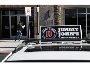 In this Wednesday, Feb. 6, 2019, photo, Tyler Schwecke, a delivery driver for Jimmy John's, makes a delivery in Las Vegas. Food delivery services like Uber Eats and GrubHub are taking off like a rocket, but some restaurants aren't on board. This week, Jimmy John's sandwich chain launched a national ad campaign promising never to use third-party delivery.