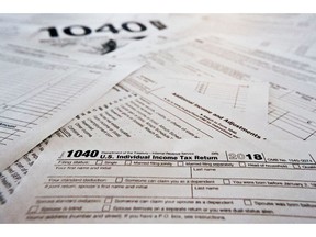 FILE - This Feb. 13, 2019 file photo shows multiple forms printed from the Internal Revenue Service web page that are used for 2018 U.S. federal tax returns in Zelienople, Pa.  It's tough to know all the answers at tax time, particularly in a year with massive tax law changes. Sometimes people need help, but where should they turn? There are several options.