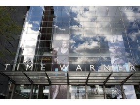FILE - In this Oct. 24, 2016, file photo, clouds are reflected in the glass facade of the Time Warner building in New York. A federal appeals court on Tuesday, Feb. 26, 2019 upheld AT&T's $81 billion takeover of Time Warner, approving one of the biggest media deals on record in the face of opposition from the Trump administration. The combination of one of the country's largest wireless carriers and TV providers with a major TV and movie company has already reshaped the media landscape.
