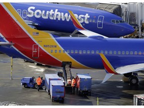 FILE- In this Feb. 5, 2019, file photo Southwest Airlines planes are loaded at Seattle-Tacoma International Airport in Seattle. Federal officials have told Southwest Airlines to fix the way it calculates the weight of luggage loaded on flights after finding frequent mistakes. Southwest said Tuesday, Feb. 19, that it made improvements in its methods for calculating weight and the balance of loads during 2018.
