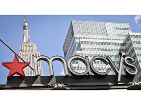 FILE- This May 2, 2017, file photo shows corporate signage at Macy's flagship store in New York. Macy's Inc. reports financial results Tuesday, Feb. 26, 2019.
