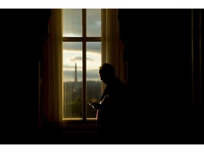 FILE- In this Jan. 24, 2019, file photo the Washington Monument is visible through a window of the U.S. Capitol building at sunset on Capitol Hill in Washington. On Wednesday, Feb. 13, the Treasury Department releases federal budget data for December.