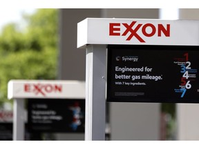 FILE- This April 25, 2017, file photo, shows Exxon service station signs in Nashville, Tenn. Exxon Mobil Corp. reports earnings Friday, Feb. 1, 2019.
