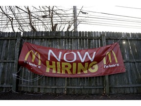 FILE- In this Jan. 3, 2019, file photo an employment sign hangs from a wooden fence on the property of a McDonald's restaurant in Atlantic Highlands, N.J. On Friday, Feb. 1, the U.S. government issues the January jobs report, which will reveal the latest unemployment rate and number of jobs U.S. employers added.
