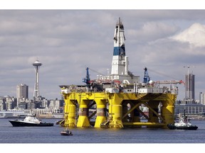 FILE - In this May 14, 2015, file photo, the oil drilling rig Polar Pioneer is towed toward a dock in Elliott Bay in Seattle. The government says U.S. oil production will keep climbing and set new records in 2019 and 2020 while oil prices will remain below last year's levels. The U.S. Energy Information Administration said Tuesday, Feb. 12, 2019, it expects the United States to pump 12.4 million barrels of crude a day in 2019 and 13.2 million barrels a day in 2020.