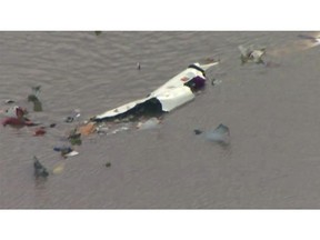 This image taken from video provided by KRIV FOX 26 shows the scene of a cargo plane crash on Saturday, Feb. 23, 2019 in Trinity Bay, just north of Galveston Bay and the Gulf of Mexico in Texas.  Lynn Lunsford with the Federal Aviation Administration did not immediately know the status of the people aboard and the Chambers County Sheriff's Office could not immediately be reached for comment.  (KRIV FOX 26 via AP)
