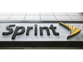 FILE - This April 30, 2018, file photo shows signage for a Sprint store in New York's Herald Square. The top executives of T-Mobile and Sprint are making the case to Congress that their proposed $26.5 billion merger wouldn't hurt competition and jack up the prices consumers pay for wireless service.