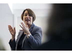 In this Sunday, Feb. 24, 2019, photo, U.S. Sen. Amy Klobuchar, D-Minn., speaks to voters during a campaign stop at a home in Nashua, N.H. U.S. Sen. and presidential hopeful Klobuchar has built a reputation as an effective champion for consumer safety. She also aggressively advocated for the medical device industry - a big employer in her home state of Minnesota - in ways that complicate her reputation as a consumer defender. Some consumer advocates say her work has helped put patients at risk.