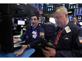 FILE- In this Feb. 8, 2019, file photo specialist Peter Mazza, left, and trader James Lamb work on the floor of the New York Stock Exchange. The U.S. stock market opens at 9:30 a.m. EST on Tuesday, Feb. 26.