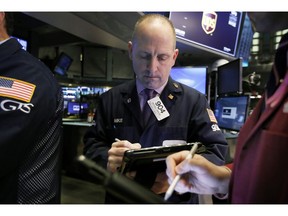 FILE- In this Feb. 5, 2019, file photo trader Michael Urkonis works on the floor of the New York Stock Exchange. The U.S. stock market opens at 9:30 a.m. EST on Thursday, Feb. 14.